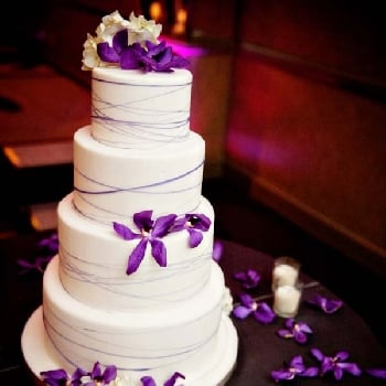 White 4 Tier Cake With Purple Flowers