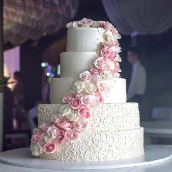 A Large Tiered Wedding Cake  With Pink Roses